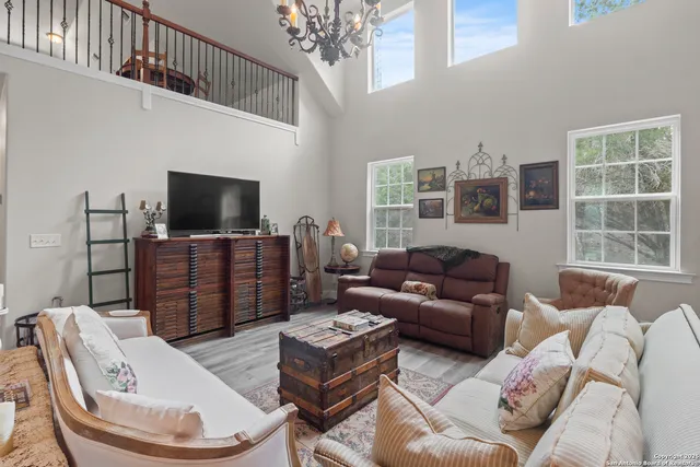 a living room with furniture a flat screen tv and a window