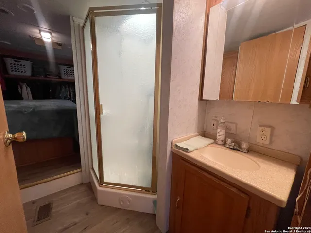 a kitchen with sink a stove a refrigerator and chairs