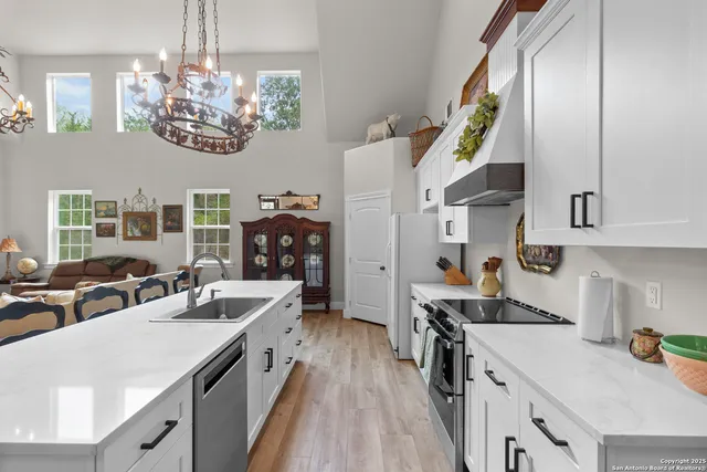 a view of a dining room with furniture wooden floor and chandelier