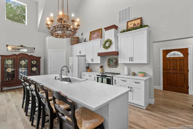 a kitchen with white cabinets and white appliances