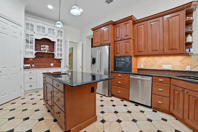 a kitchen with stainless steel appliances a stove a sink and a refrigerator