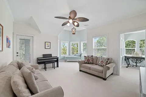 a dining room with furniture a rug and a large window