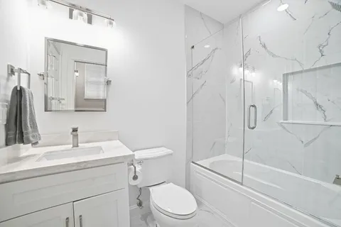 a bedroom with furniture and a fan