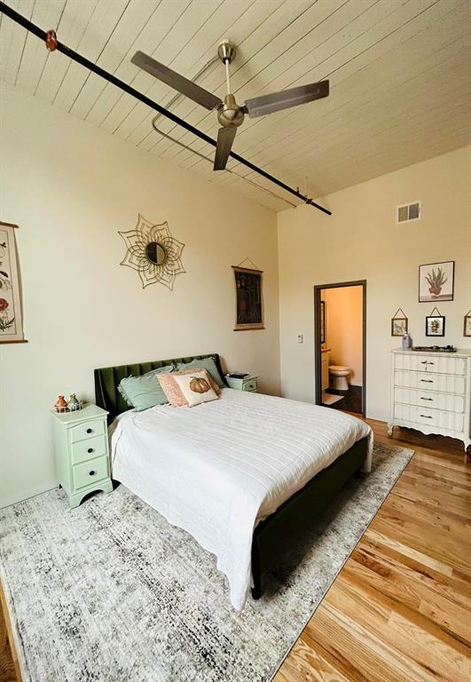 201 East Chambers Street, Unit 203 Cleburne, TX 76031 - Photo 2 of 8 a bedroom with a bed and wooden floor