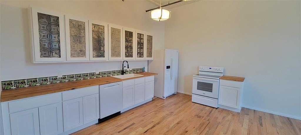 201 East Chambers Street, Unit 203 Cleburne, TX 76031 - Photo 4 of 8 a room with a bed and a window