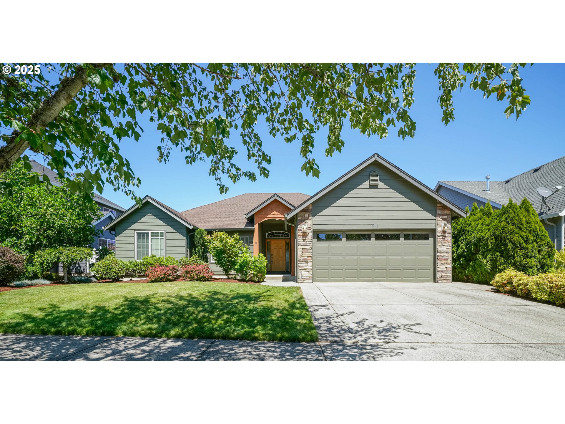 1897 Northeast Lucy Belle Street McMinnville, OR 97128 - Photo 1 of 39 a front view of a house with a garden and plants