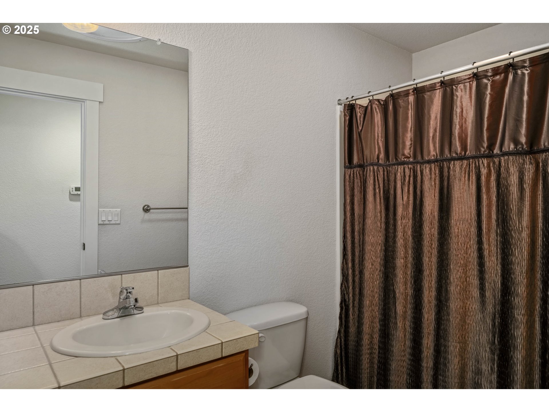 1897 Northeast Lucy Belle Street McMinnville, OR 97128 - Photo 21 of 39 a bathroom with a sink and a mirror