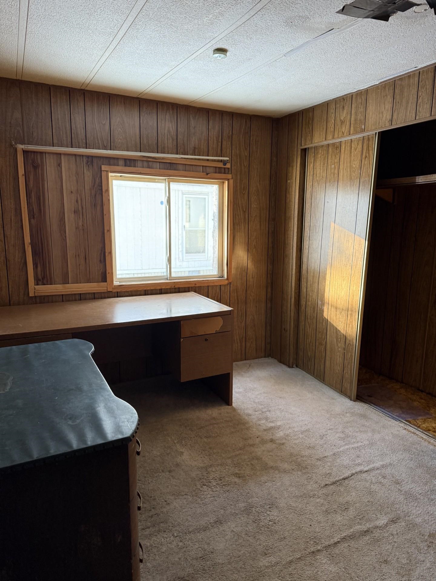1625 Cary Street Ashland, WI 54806 - Photo 6 of 8 Office with light carpet, built in study area, and wood walls