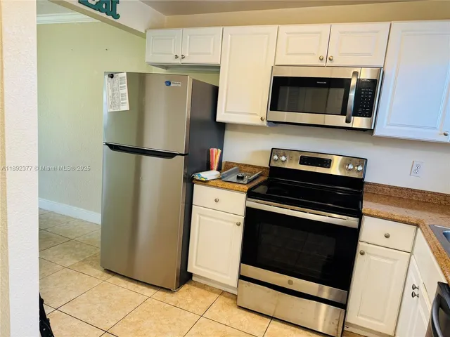 a kitchen with stainless steel appliances a refrigerator stove and microwave