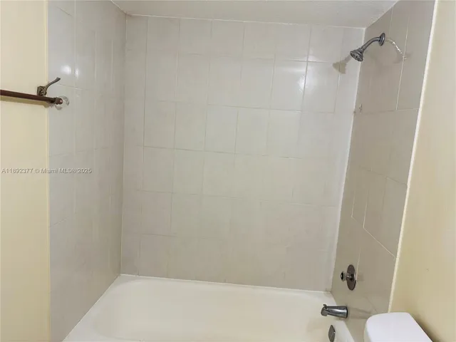 a bathroom with a shower and a toilet