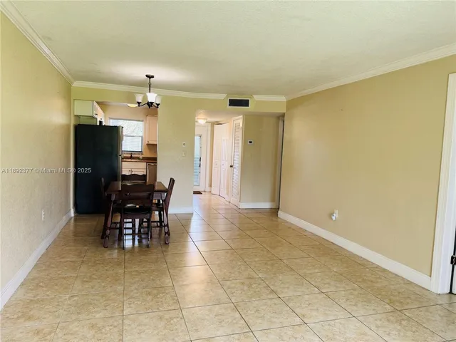 a view of a dining room with furniture and a chandelier fan