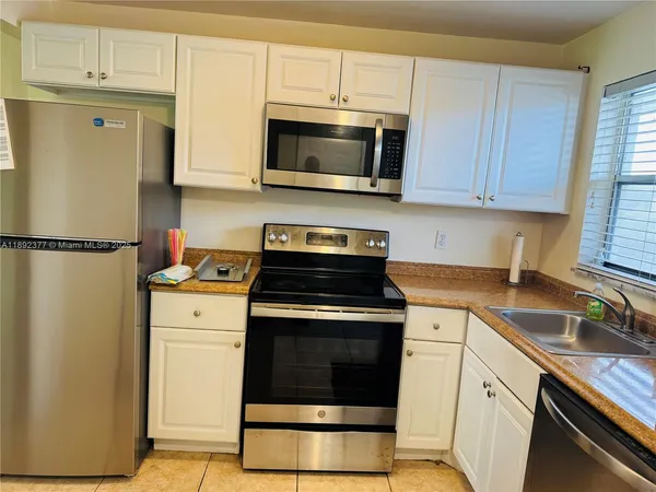 a kitchen with a stove and a microwave