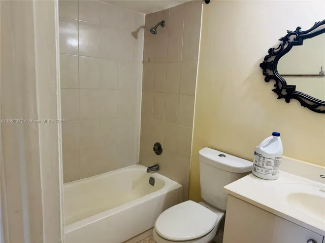 a white toilet sitting next to a bath tub