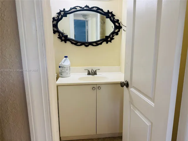 a bathroom with a sink and mirror