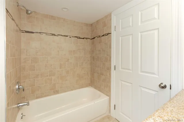 a bathroom with a granite countertop toilet a sink and a mirror