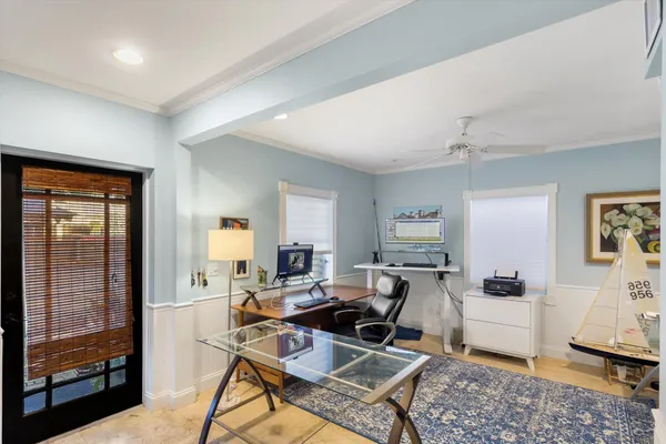 a kitchen with a refrigerator a sink and white cabinets