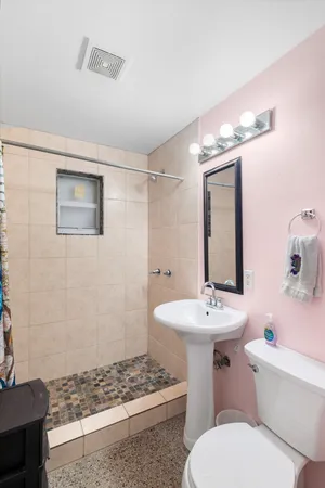 a view of a patio with table and chairs potted plants with wooden floor and fence