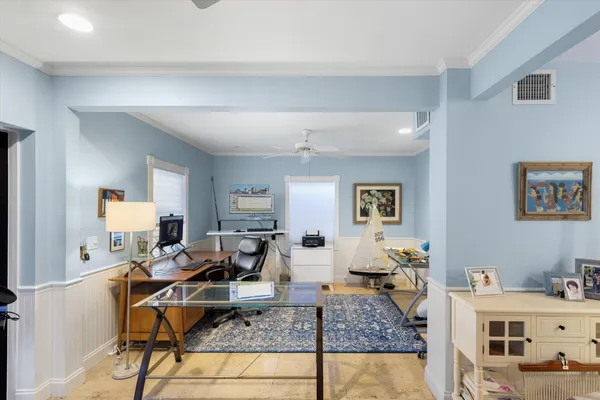 a living room with stainless steel appliances furniture and a view of kitchen
