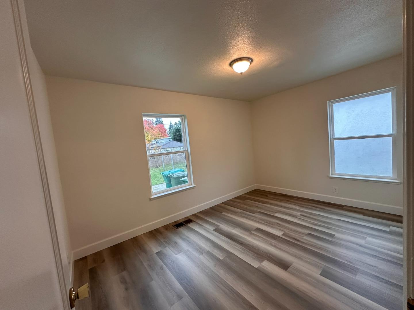 1220 Church Street Lodi, CA 95240 - Photo 18 of 31 an empty room with wooden floor and windows