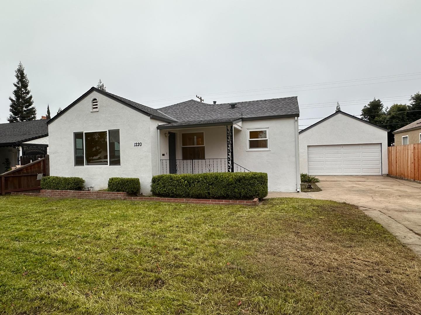 1220 Church Street Lodi, CA 95240 - Photo 2 of 31 a front view of a house with a yard and garage