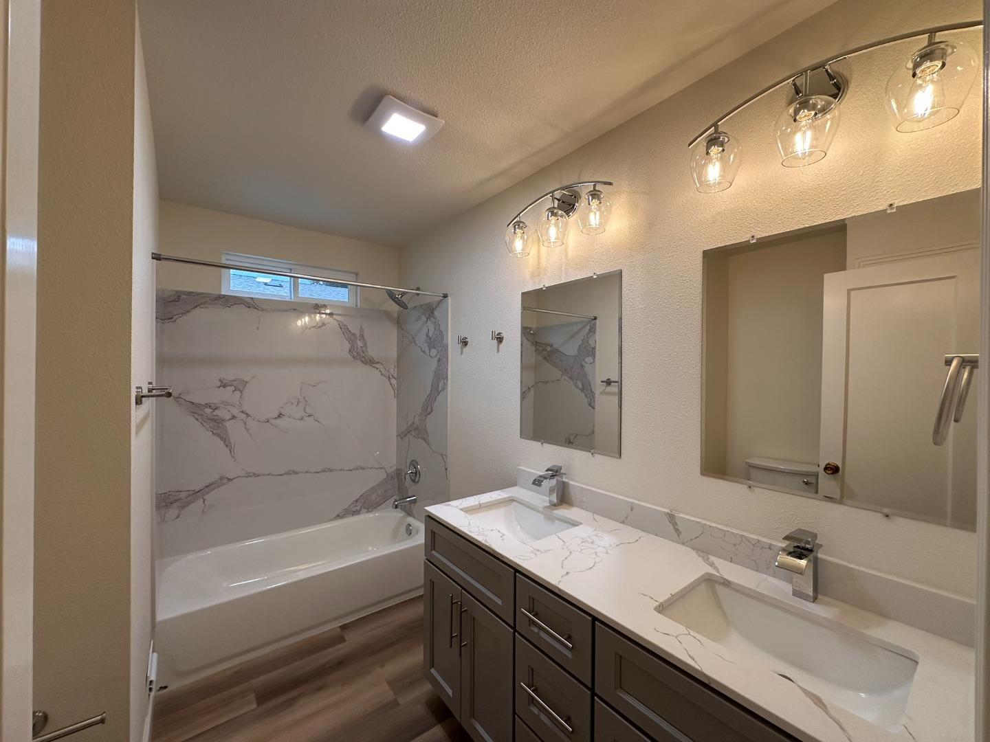 1220 Church Street Lodi, CA 95240 - Photo 21 of 31 a bathroom with a double vanity sink mirror double and bathtub