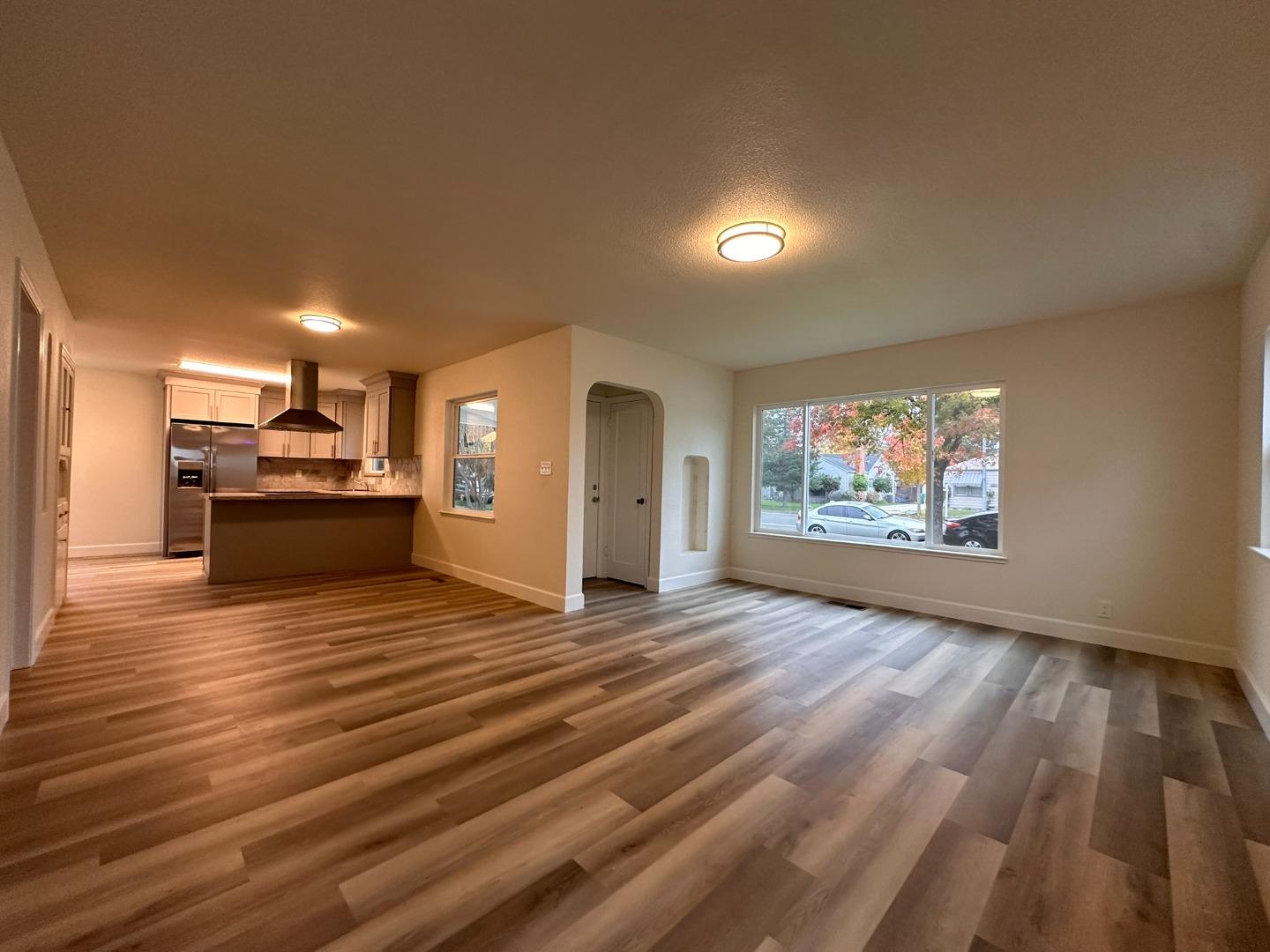 1220 Church Street Lodi, CA 95240 - Photo 3 of 31 a view of a room with kitchen island stainless steel appliances wooden floor and window