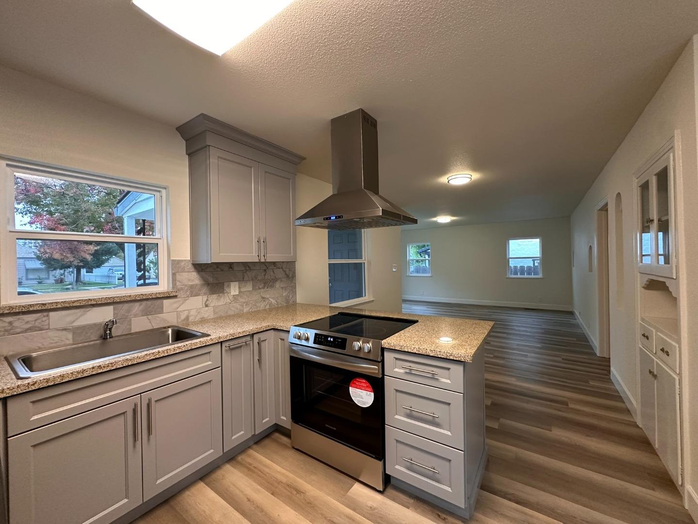 1220 Church Street Lodi, CA 95240 - Photo 7 of 31 a kitchen with stainless steel appliances granite countertop a stove and a sink