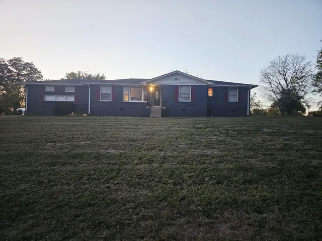 a view of a brick house with a big yard