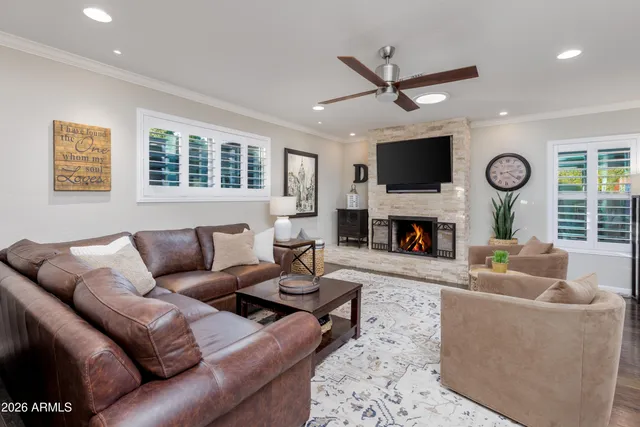 a view of a dining room and livingroom with furniture wooden floor a chandelier