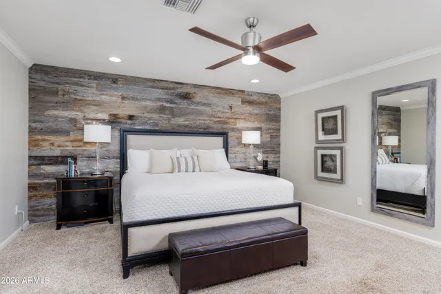 a bedroom with a bed and a flat screen television