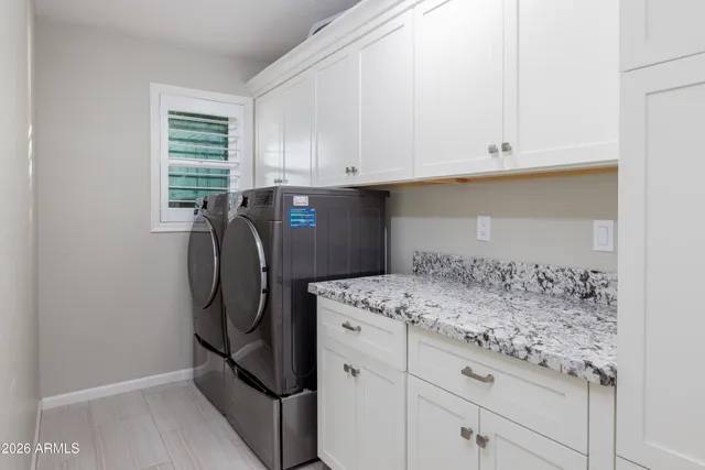 a view of a roof deck with table and chairs under an umbrella