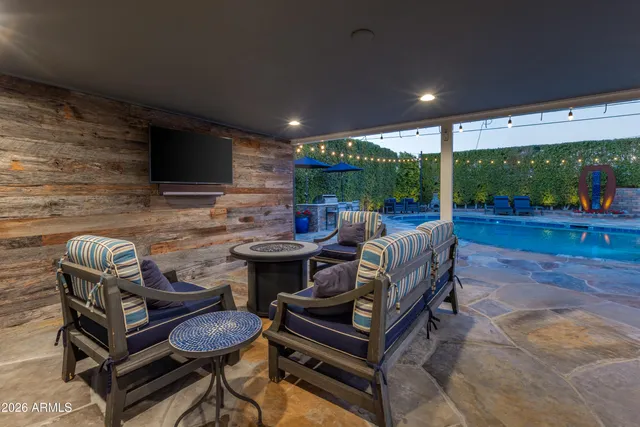 a roof deck with table and chairs under an umbrella