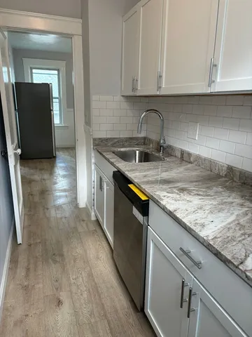 a kitchen with a sink and cabinets