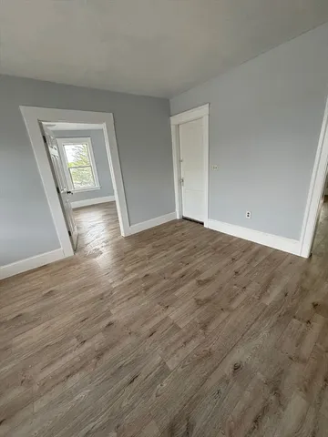 a view of an empty room and wooden floor