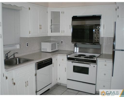 10 Eagle Road Edison, NJ 08820 - Photo 7 of 12 a kitchen with a stove and a microwave