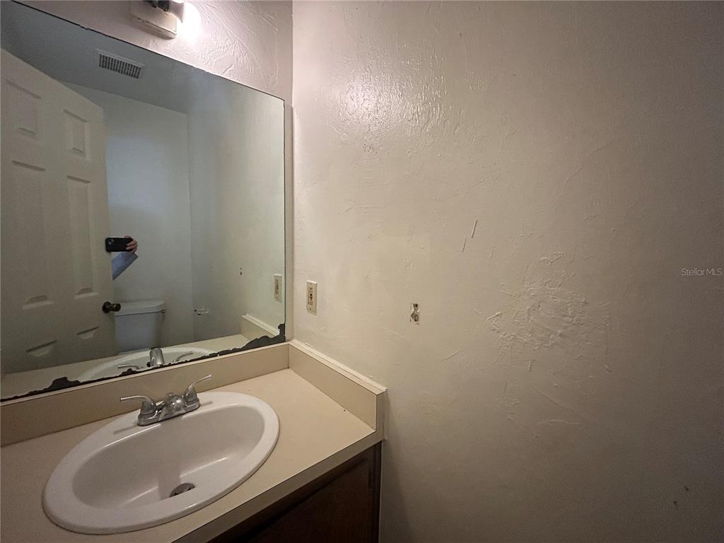 707 Southwest 68th Terrace, Unit A Gainesville, FL 32607 - Photo 14 of 16 a bathroom with a sink and a mirror