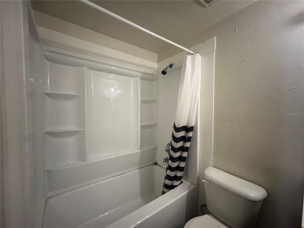 707 Southwest 68th Terrace, Unit A Gainesville, FL 32607 - Photo 10 of 16 a bathroom with a toilet and a shower