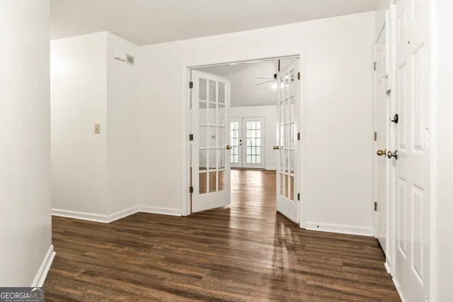 a view of a hallway with wooden floor