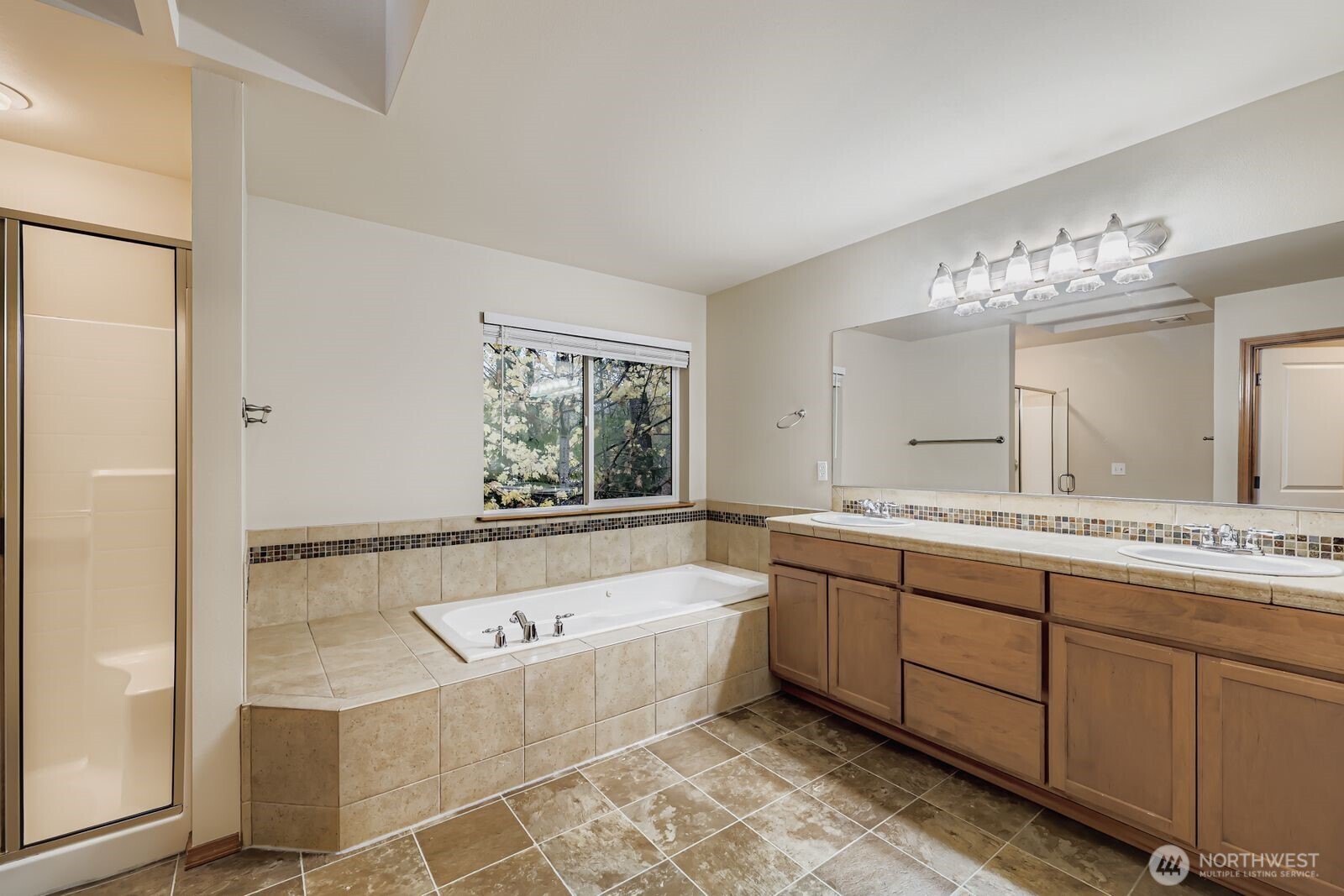 16305 37th Drive Southeast Bothell, WA 98012 - Photo 17 of 34 a bathroom with a bathtub a double vanity sink and mirror
