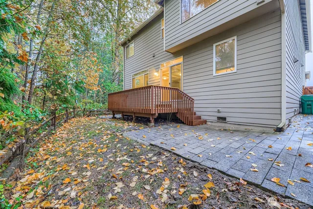 a view of a house with a yard and wooden fence
