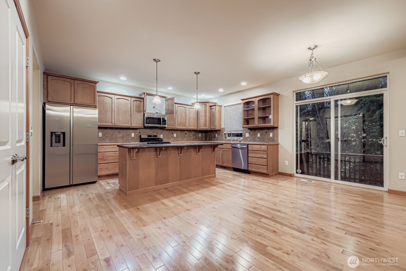 16305 37th Drive Southeast Bothell, WA 98012 - Photo 9 of 34 a kitchen with stainless steel appliances granite countertop a refrigerator oven a sink dishwasher and white cabinets with wooden floor