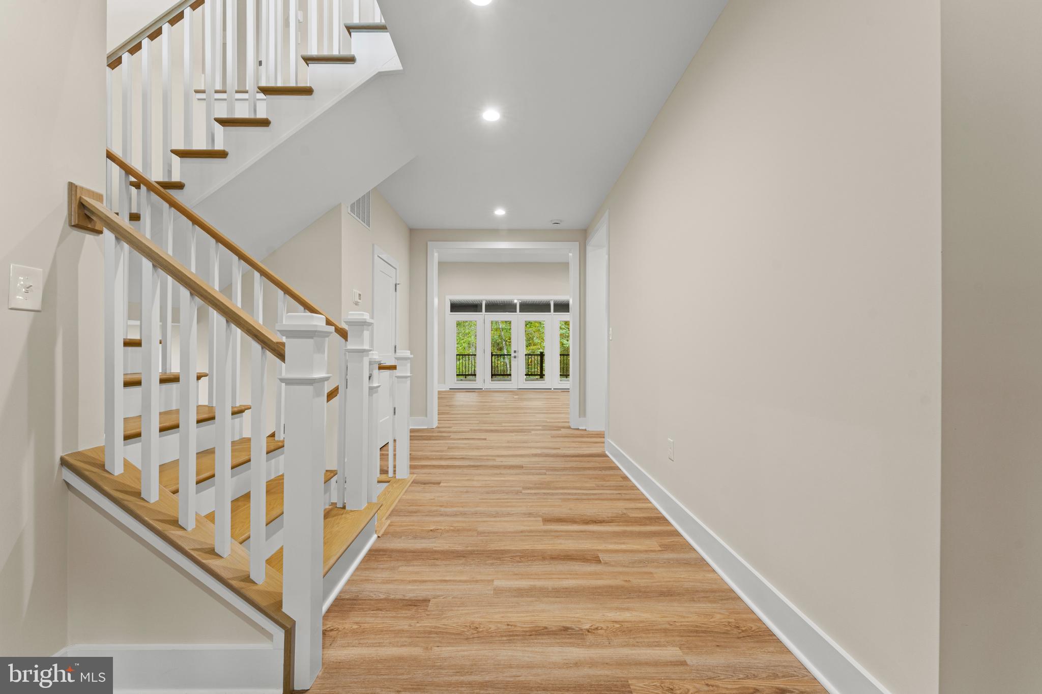 5725 Turner Road Broad Run, VA 20137 - Photo 12 of 57 a view of staircase with lots of frames on wall and wooden floor
