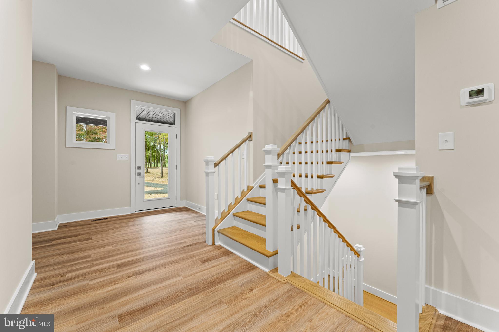 5725 Turner Road Broad Run, VA 20137 - Photo 14 of 57 a view of front door with wooden floor and stairs