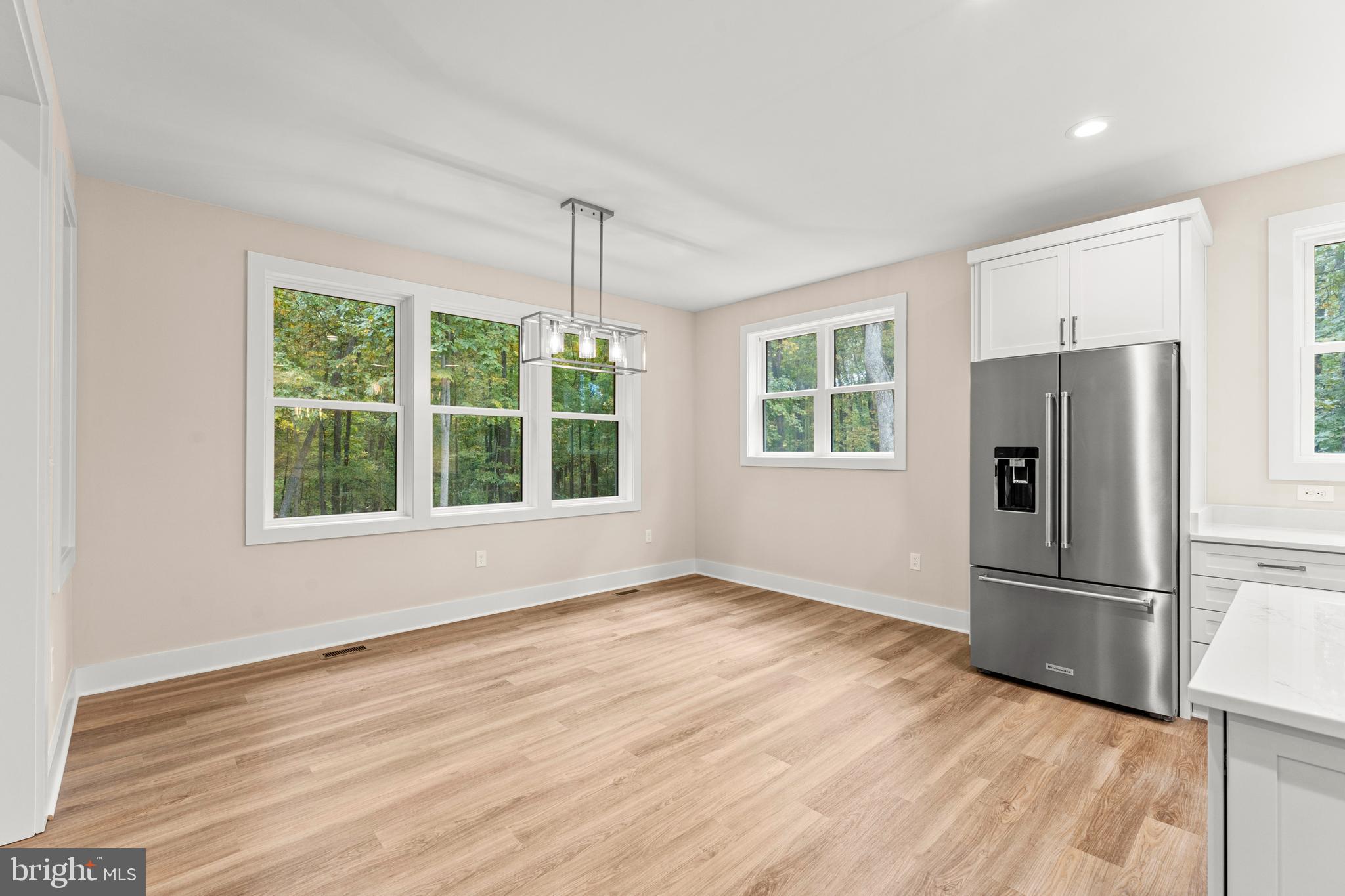 5725 Turner Road Broad Run, VA 20137 - Photo 17 of 57 a view of an empty room with wooden floor fridge and a window
