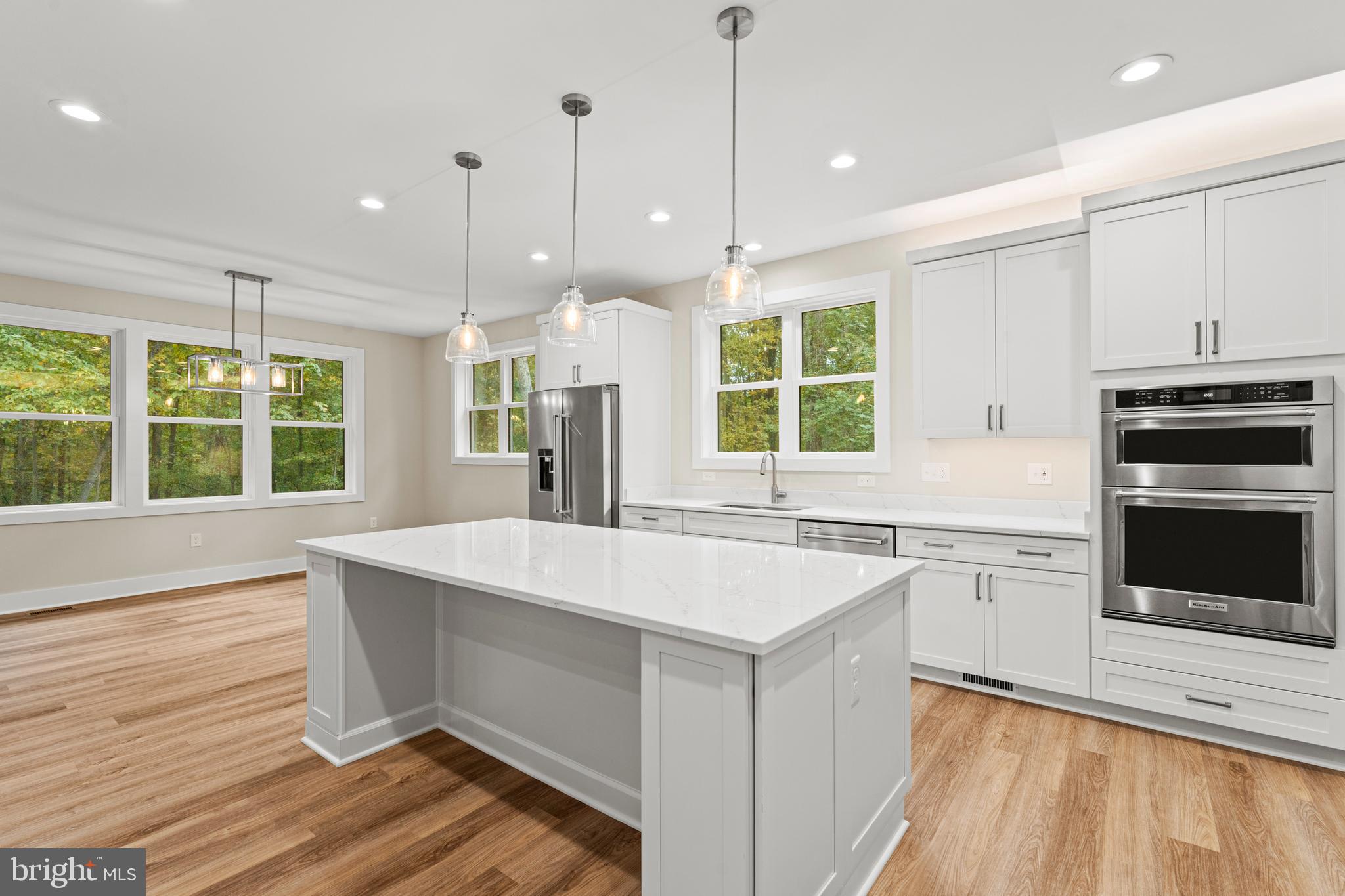 5725 Turner Road Broad Run, VA 20137 - Photo 18 of 57 a large kitchen with kitchen island a stove a sink and a wooden floors