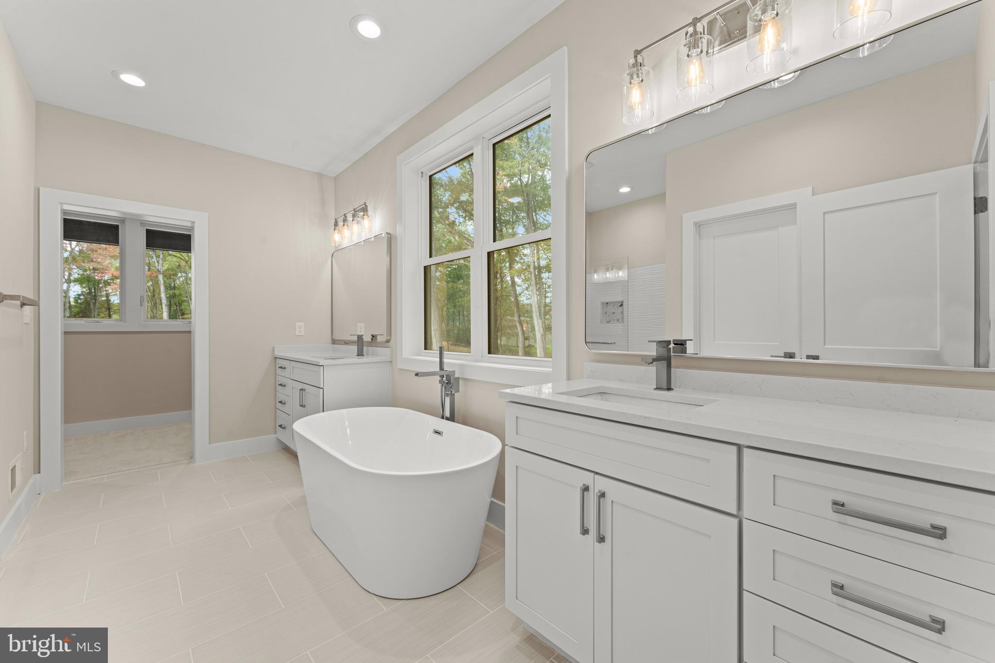 5725 Turner Road Broad Run, VA 20137 - Photo 27 of 57 a bathroom with a granite countertop sink and mirror with bathtub
