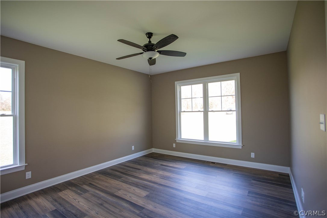 460 Jamestown Road Farmville, VA 23901 - Photo 21 of 50 an empty room with wooden floor a ceiling fan and windows