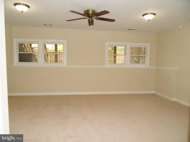a view of a livingroom with a ceiling fan and window