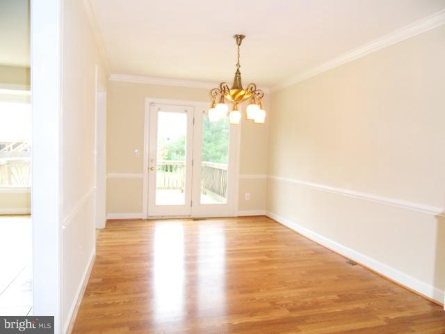 43441 Postrail Square Ashburn, VA 20147 - Photo 2 of 24 a view of a room with wooden floor chandeliers and kitchen view