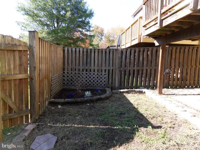 a view of a backyard with wooden fence